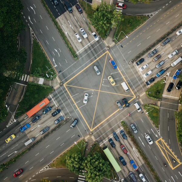 low-angle photography of vehicles passing road at daytime